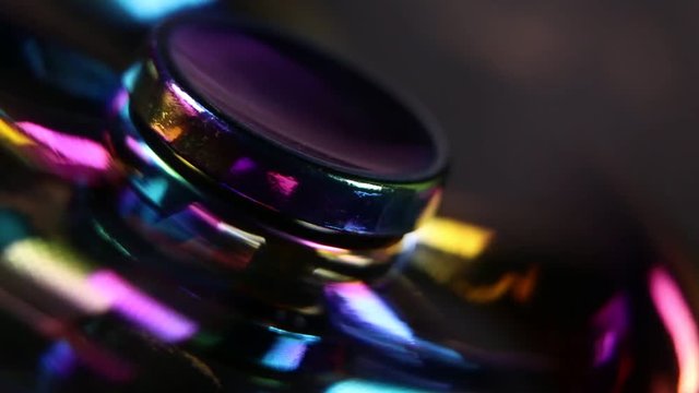 A spinning fast colorful fidget spinner macro close up
