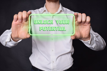 A businessman shows an inscription:UNLOCK YOUR POTENTIAL