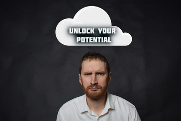 Above the businessman hangs a cloud with the inscription:UNLOCK YOUR POTENTIAL