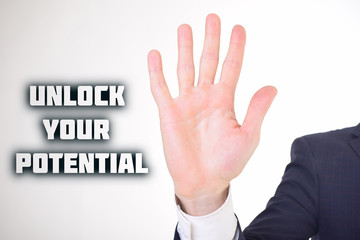 A businessman shows an inscription:UNLOCK YOUR POTENTIAL