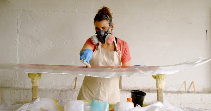 Woman making surfboard 