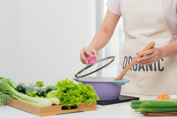 Young Woman Cooking in the kitchen. Healthy Food. Dieting Concept. Healthy Lifestyle. Cooking At Home. Prepare Food