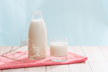 Dairy products. Bottle with milk and glass of milk on wooden table