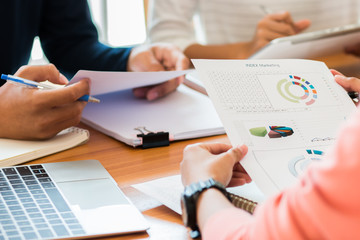 Co working team meeting concept: Business people working and studying together use digital tablet laptop computer with document paper in office, discuss finance and marketing solution in working place