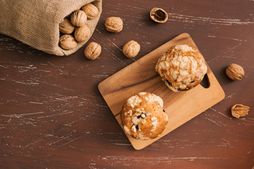Tasty homemade walnut muffins on table. Sweet pastries