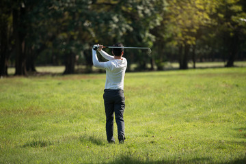 Golfers asia man show hit sweeping at green lawn.