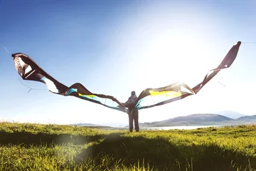 Fotobehang Luchtsport Man woman stands with kite in sun light