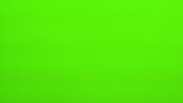 Blue casino dice being rolled and settling on craps (double one) on a green screen. Multiple rolls