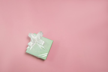 Green gift box on color background.