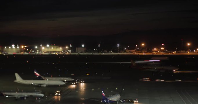 MOSCOW, RUSSIA - AUGUST 07, 2017: Timelapse night shot of plane and service vehicles traffic in Sheremetyevo International Airport, the busiest one in the country in 2017