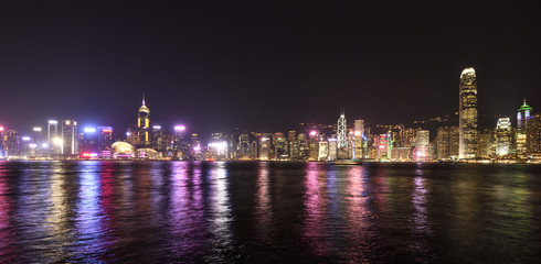Business District of Hong Kong Island buildings reflecting their lights off the Victoria Harbour