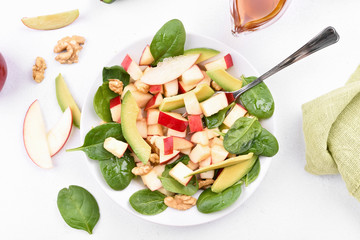 Fruit salad with apples, avocado, spinach and nuts