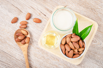 Almonds in white bowl and cup of almond milk