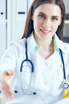 Smiling Female Doctor Stretching Hand For Handshake. Welcome Introduction Or Thanks Gesture Test Work Examine Patient Congratulation Help Exam Teamwork Deal Concept.