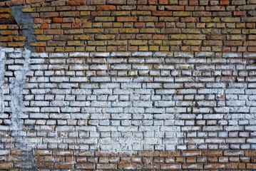 brown brick old wall with white paint on bricks