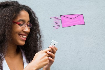 African American woman sending email with the mobile phone