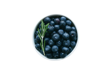 Fresh wild blueberries in white bowl on white isolated background with clipping paths in top view flat lay copy space. Blueberry is antioxidant food and healthy fruits with high vitamin C.