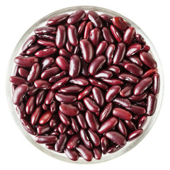 Uncooked red kidney beans in glass bowl isolated on white background with clipping path