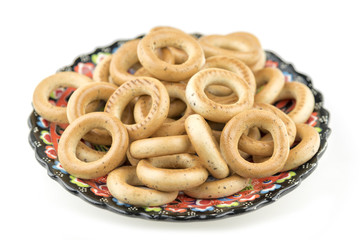 Fresh baked bagels on plate. Bagel breakfast on isolated white background. Diet snack food.