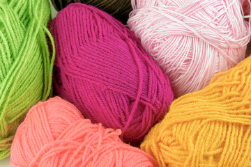 Colored balls of yarn. Knit yarn for knitting. Skeins of fabric.