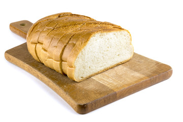 Fresh baked bread on wooden cutting board. Bun slice on isolated white background.