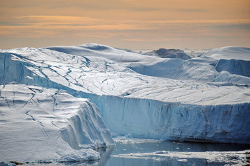 Icebergs in the light of the rays of the sunset