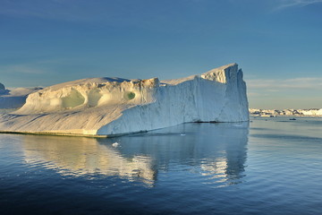 Icebergs in the light of the rays of the sunset