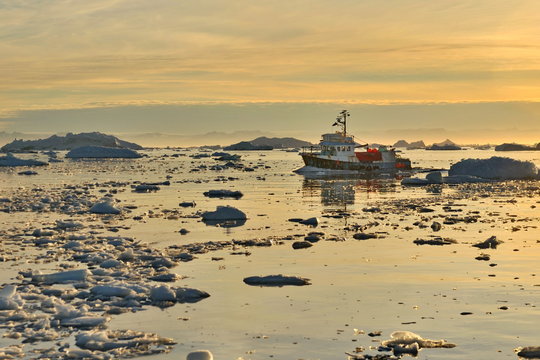 Fototapeta Greenland. Small fishing ships in the water area of the village Ilulissat