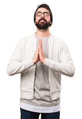Hipster man in zen position on white background