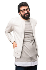 Hipster man with back pain on white background