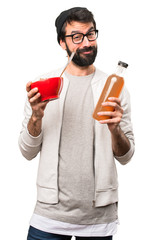Happy Hipster man holding an orange juice on white background