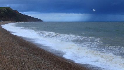 Fototapeta na wymiar Rainy on a pebble beach near town of Seaton in Devon on the Jurassic Coast