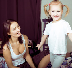 portrait of young happy mother playing with her daughter