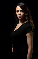 Beautiful woman with evening make-up in black dress