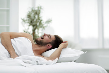 Obraz na płótnie Canvas business man falling asleep in the comfortable hotel room