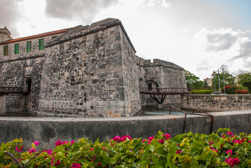 Castillo de la Real Fuerza. The old fortress Castle of the Royal Force and flower bed with red colors. Havana, Cuba.