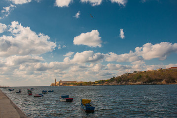 The Castillo Del Morro lighthouse in Havana. View from the waterfront Malecon on the water and boats. The old fortress Cuba