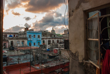 Evening landscape. Top view of the street, on ordinary houses with roofs and balconies, where clothes dry. Havana. Cuba