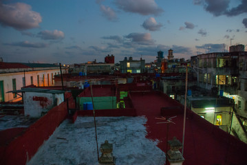 Night landscape. Top view of the street, on ordinary houses with roofs and balconies, where clothes dry. Havana. Cuba