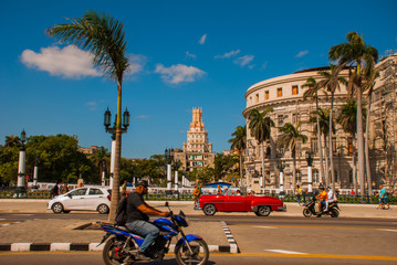 Capitolio Nacional, El Capitolio. Old classic retro cars and motorbikes are on the way. Havana. Cuba