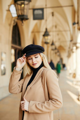 Fototapeta premium Young pretty girl walking on the street and smile