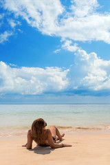 Fototapeta na wymiar woman sunbathing lying down on the tropical beach