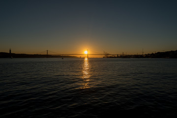 Fototapeta na wymiar Sunset over 25th April Bridge, Lisbon - Portugal