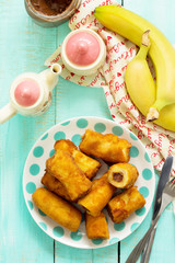 Homemade dessert of fried bananas fried stuffed with chocolate. Top view flat lay background.