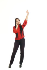 Obraz premium happy woman in red talking on mobile phone and showing gestures by hand. isolated on white background