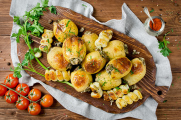 Grilled potatoes stuffed with bacon and herbs