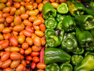 Green peppers and tomatoes at market