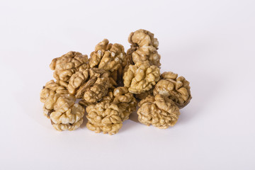 Shelled whole walnuts on white