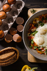 Scrambled eggs with sweet pepper in a frying pan.