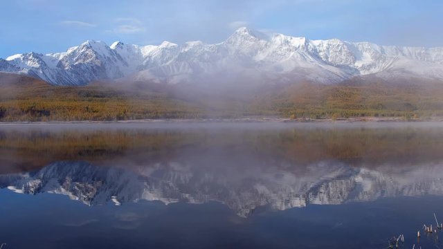 View on Altai lake Dzhangyskol on mountain plateau Eshtykel. North Chui ridge is reflecting in the water